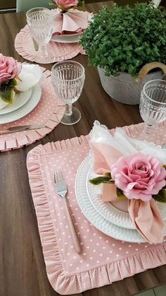 the table is set with pink and white dishes