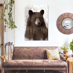 a bear is shown in this living room with a brown couch and wall hangings