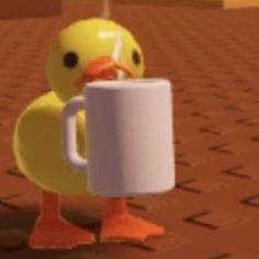 a yellow duck with a mug in its beak is standing on a brown tile floor