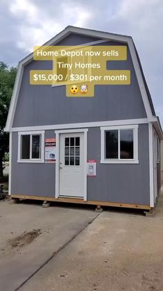 a gray barn with a sign that says home depot now sells tiny homes $ 15, 000 / $ 31 per month