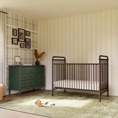 a baby's room with a crib and dresser