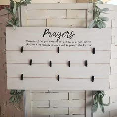 a sign that says, prayer on it and some leaves around the frame with magnets