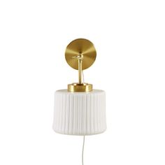 a white and gold table lamp on a white background