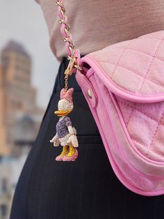 Add a touch of Disney wherever you go! Our Daisy Duck Disney Classic Bag Charm has proven to be a Disney fan favorite and is the must-have Disney keychain. It's the perfect addition to any purse, backpack, or tote. Daisy Duck's likeness is bedecked in 1,800 hand-applied crystals, creating the classic Daisy Duck outfit everyone knows and loves. Enhance your bag with our stylish Bag Charms crafted from premium materials. Please consider your bag's material to prevent potential surface impact. Enjo Daisy Duck Outfit, Duck Outfit, Disney Keychain, Kids Gadgets, Trendy Bags, Duck Cloth, Purse Backpack, Disney Bag, Daisy Duck