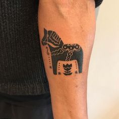 a man's arm with a black and white tattoo of an elephant on it