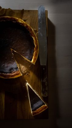 a chocolate pie on a cutting board with a knife