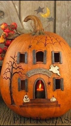 a carved pumpkin with an image of a house on the front and windows in the back