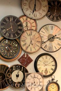 many different clocks are hanging on the wall