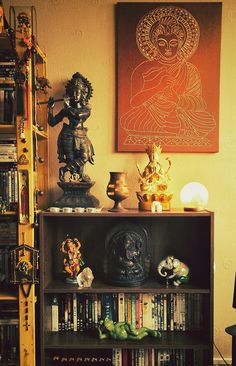 a bookshelf filled with lots of books next to a painting on the wall