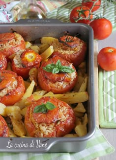 a pan filled with tomatoes and pasta on top of a table