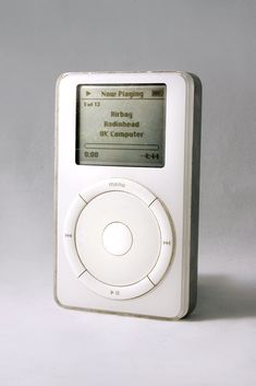 an old white ipod sitting in front of a gray background with the words new flying on it