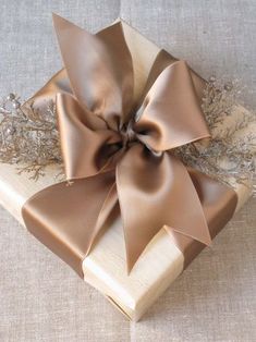 a brown bow on top of a wooden box