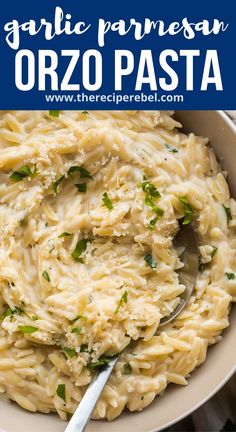 garlic parmesan orzo pasta in a white bowl with a spoon on the side