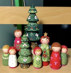 a group of wooden christmas trees sitting on top of a table