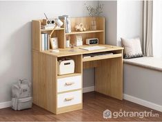 a wooden desk with two drawers and a window in the back ground, next to a white chair