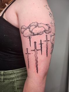 a woman with a tattoo on her arm has lightning and clouds in the sky above them