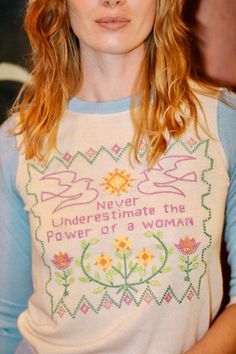 a woman with long hair wearing a sweater