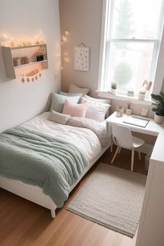 a small bedroom with a bed, desk and window in the corner is lit up by fairy lights