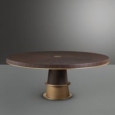 an oval wooden table with gold accents on the top and base, against a gray background