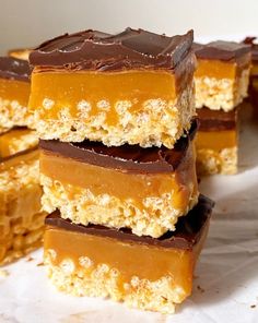 several pieces of chocolate peanut butter bars stacked on top of each other