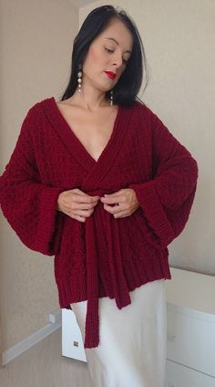 Handmade knit oversized kimono cardigan with wide sleeves. Wool chunky hand knit jacket with belt. V neck tie waist waffle knit sweater in burgundy. Hand knit kimono cardigan with belt MADE TO ORDER Yarn composition: 50% wool, 50% acrylic Color (as shown): 57 bordeaux SIZE CHART Size XXS-XS: Width: 50-53 cm Length: 70-72 cm Size XS-S: Width: 54-55 cm Length: 70-72 cm Size S-M: Width:56-57 cm Length:70-72 cm Size M-L: Width: 58-60 cm Length: 70-72 cm Size L-XL: Width: 61-63 cm Length: 71-73 cm Si Knitted Belt, Kimono With Belt, Wide Sleeve Sweater, Knit Kimono, Winter Kimono, Kimono Sweater, Waffle Knit Sweater, Sweater Oversized, Sweater Oversize