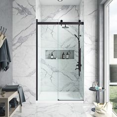 a walk in shower sitting inside of a bathroom next to a white tiled wall and floor