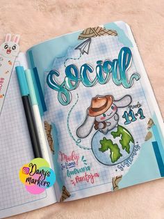 an open notebook with the word social on it and a pen sitting next to it