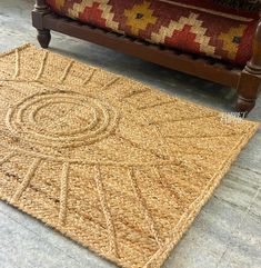 a rug on the floor next to a couch