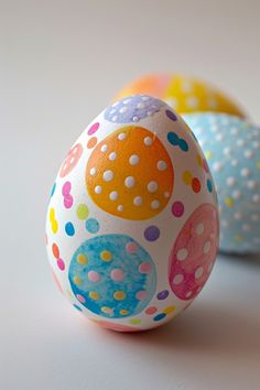 two decorated eggs sitting next to each other on a table