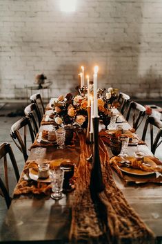 a long table set with candles and place settings for an elegant fall dinner party setting