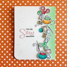 a handmade card with scissors and sewing supplies on an orange tablecloth that says you're sew amazing