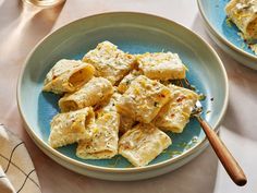 two plates filled with ravioli on top of a table