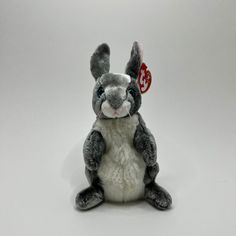 a small stuffed rabbit sitting on the ground