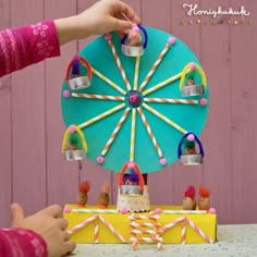 a child is playing with a toy ferris wheel