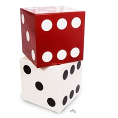 two dices stacked on top of each other in the shape of a block with white and black dots