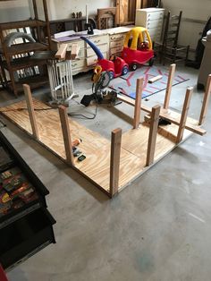 an unfinished garage with toys and tools on the floor