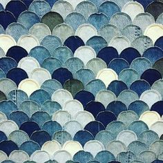 an abstract blue and white background with circles in the shape of fish scales, made up of watercolor paper