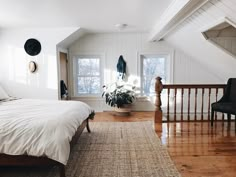 a bed sitting in the middle of a bedroom on top of a wooden floor