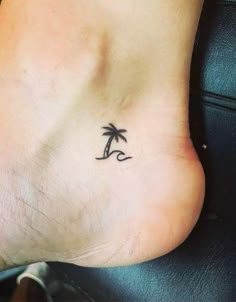 a small palm tree tattoo on the foot