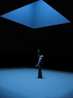 a person standing in the middle of a dark room