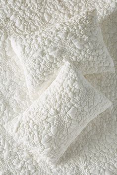 an image of a white quilt on the bed