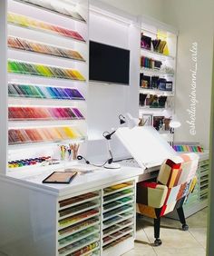 a room with lots of different colored papers on the wall and desks in front of it