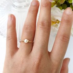 ✨ Mother Of Pearl Ring with 14K Gold Filled or Sterling Silver wire 🐚 Mother of pearl, also known as shell beads, is a stone of protection. It brings the gentle healing power of the sea. It is a stress-relieving stone; relaxing, soothing and calming to the emotions 💙 Tiny, dainty and cute Mother Of Pearl ring. You can wear it alone or stack them together. Make a cute pinky ring. Sizing: *Gemstone Diameter: 4 mm *Ring Band: 0.8 mm * Handmade in your ring size with 14K gold-filled wire or Sterli Pearl Rings With Pearl Charm As Gift, Gold Wire Wrapped Pearl Ring Gift, Adjustable Fine Jewelry Pearl Ring As Gift, Adjustable Fine Jewelry Pearl Ring For Gift, Wire Wrapped Pearl Wedding Ring, Adjustable Pearl Ring As Fine Jewelry Gift, Dainty Pearl Ring With Pearl Charm For Gifts, Dainty Pearl Ring With Pearl Charm As Gift, Adjustable Pearl Birthstone Ring For Wedding