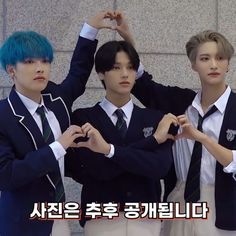 three young men in school uniforms are posing for the camera