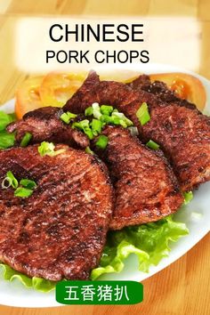 chinese pork chops on a plate with lettuce and tomatoes