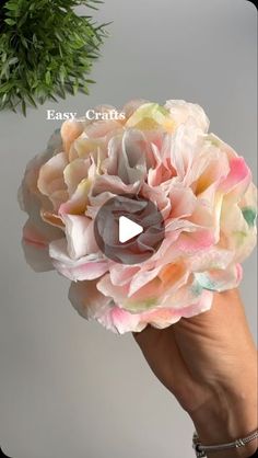 a person holding a fake flower in their hand with the words easy crafts on it