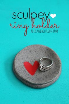 a ring holder with a red heart on it and the words sculpey ring holder