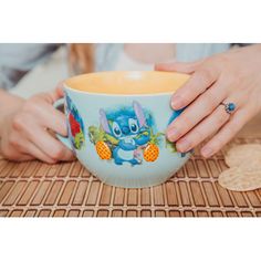 a woman is holding a bowl with an image on it and has her hands in the bowl