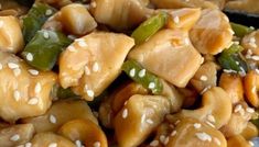 a close up view of some food with sesame seeds and chicken in it on a plate