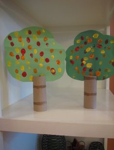 three trees made out of toilet paper on a shelf